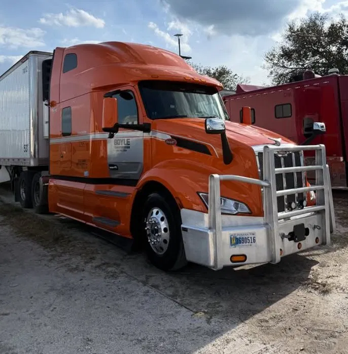 Orange Peterbilt semi truck after exterior wash